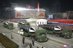 This picture taken on Jan. 14, 2021 and released by North Korea's official Korean Central News Agency shows what appears to be submarine-launched ballistic missiles during a military parade.