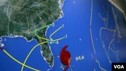 A map at the National Hurricane Center in Miami indicates Hurricane Sandy's position moving through the Bahamas off the east coast of Florida, October 26, 2012. Hurricane Sandy left at least 38 people dead as it moved through the Caribbean, following a pa