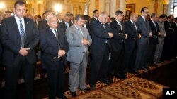 Egyptian President Mohamed Morsi, third left, attends Friday prayers in Cairo, Egypt, April 26, 2013.