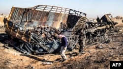 Syrians look for metal and unexploded ammunition at the site of the previous evening's Israeli airstrike that targeted shipments of weapons that belonged to Syrian government forces in Qamishli, in mainly Kurdish northeastern Syria, on Dec. 10, 2024.