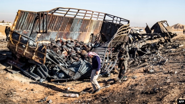 Syrians look for metal and unexploded ammunition at the site of the previous evening's Israeli airstrike that targeted shipments of weapons that belonged to Syrian government forces in Qamishli, in mainly Kurdish northeastern Syria, on Dec. 10, 2024.