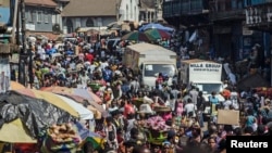 Shoppers and market vendors fill Sani Abacha Street in central Freetown, Sierra Leone, Jan. 4, 2013.