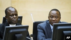 Uhuru Kenyatta (R) and a member of the Defense Council attend a hearing at the International Criminal Court (ICC) in The Hague, September 21, 2011.