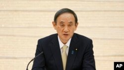 In this April 23, 2021, file photo, Japanese Prime Minister Yoshihide Suga speaks in a meeting to declare a state of emergency for Tokyo and three other prefectures at the prime minister's office in Tokyo. (AP Photo/Eugene Hoshiko, Pool, File)