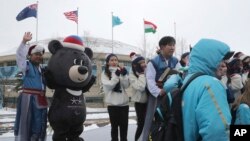 Volunteers and performers gather with Paralympic mascot Bandabi for a photo after taking part in a welcome ceremony at the Pyeongchang Olympic Village ahead of the 2018 Winter Paralympics in Pyeongchang, South Korea, March 8, 2018.