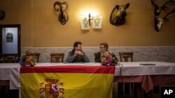 Vox's Ciudad Real provincial candidate Ricardo Chamorro, left, and Toyan Patón during a meeting with local farmers at a bar in Brazatortas, on the edge of the Alcudia valley, central Spainو April 10, 2019.