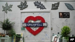 FILE - A view of the memorial wall at the Grenfell Tower in which 72 people were killed in a fire in 2017, in London, Sept. 2, 2024.