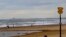 FILE - People walk on the beach near The Hague, Netherlands, Sept. 12, 2012. Five surfers drowned in rough coastal waters in the area Monday. 