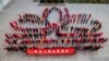 Teachers and students stand in a lotus flower formation to mark the 15th anniversary of the return of the Macau Special Administrative Region to China at a primary school in Lianyungang, east China's Jiangsu province, Dec. 19, 2014.