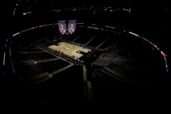 Big 12 commissioner Bob Bowlsby is seen on the big screen in an empty Sprint Center in Kansas City, Mo., as he talks to the media after canceling the remaining NCAA college basketball games in the Big 12 Conference tournament, March 12, 2020.