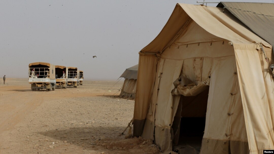 FILE - Syrian refugees board a Jordanian army vehicle at the Rakban refugee camp. A car laden with explosives killed a number of Jordanian border guards outside the camp June 21, 2016, the Jordanian army said.