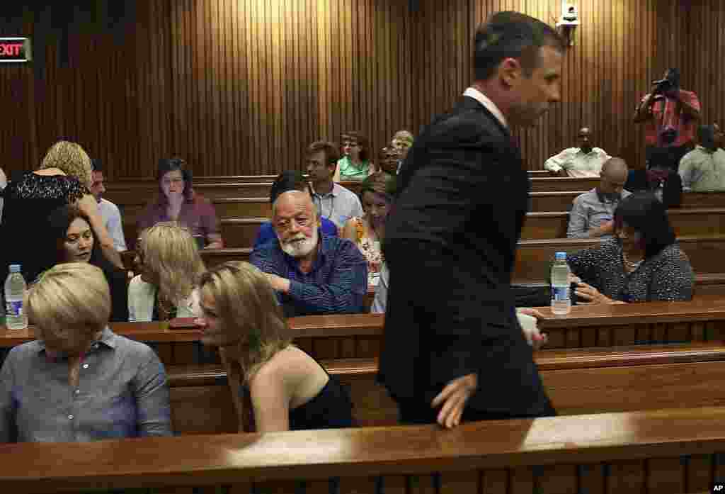 Oscar Pistorius&nbsp; passes by Steenkamp family members and supporters as he arrives in court for the fourth day of sentencing proceedings in the high court in Pretoria, South Africa, Oct. 16, 2014. 