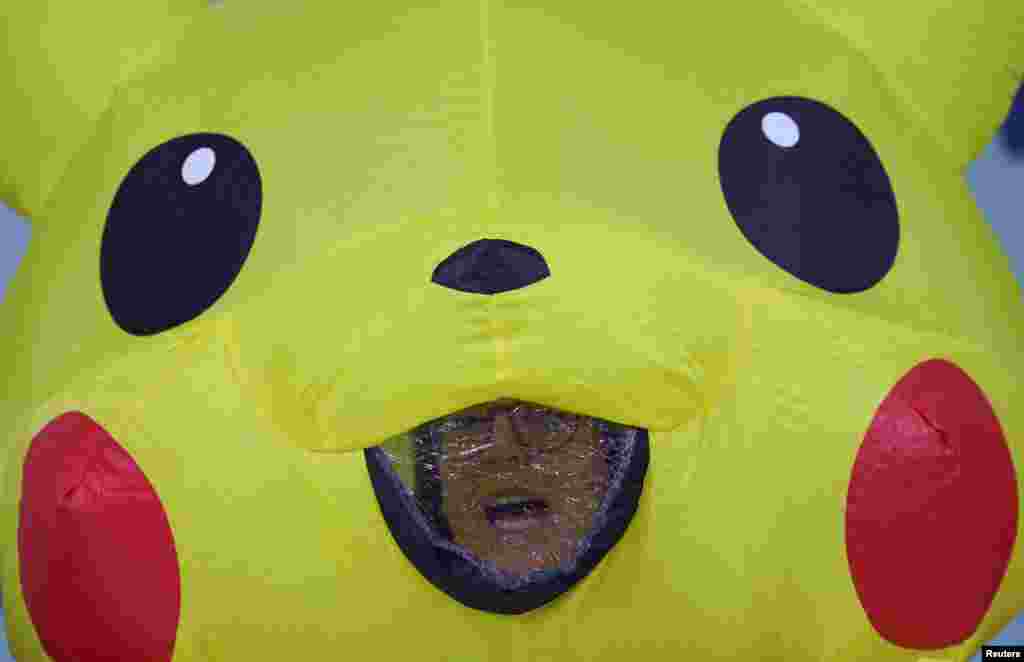 A demonstrator in a Pikachu costume reacts as global environmental activists protest the gas industry during the United Nations Climate Change Conference (COP29), in Baku, Azerbaijan.