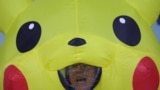 A demonstrator in a Pikachu costume reacts as global environmental activists protest the gas industry during the United Nations Climate Change Conference (COP29), in Baku, Azerbaijan, Nov. 15, 2024. 