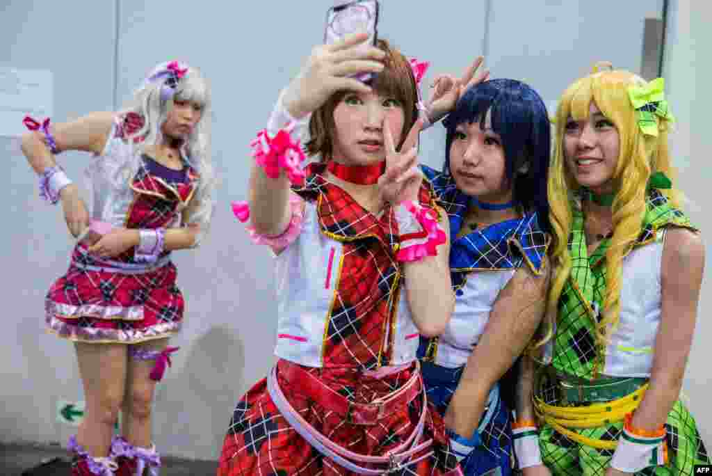 Cosplay fans (R) take selfies as comic book and gaming fans attend the annual Ani-Com and Games Fair in Hong Kong. Tens of thousands are expected to attend the annual event on animation, comics and games, from July 28 to Aug. 1.