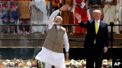 U.S. President Donald Trump and Indian Prime Minister Narendra Modi wave to the crowd at Sardar Patel Stadium in Ahmedabad, India, Monday, Feb. 24, 2020.