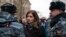 FILE - Member of the Pussy Riot punk group, Nadezhda Tolokonnikova (C) speaks to a police officer outside Zamoskvoretsky District Court in Moscow, Russia, Feb. 24, 2014.