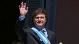 Argentina's new president Javier Milei waves at the crowd from a balcony of the Casa Rosada government palace during his inauguration day in Buenos Aires on December 10, 2023.