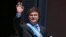 Argentina's new president Javier Milei waves at the crowd from a balcony of the Casa Rosada government palace during his inauguration day in Buenos Aires on December 10, 2023.