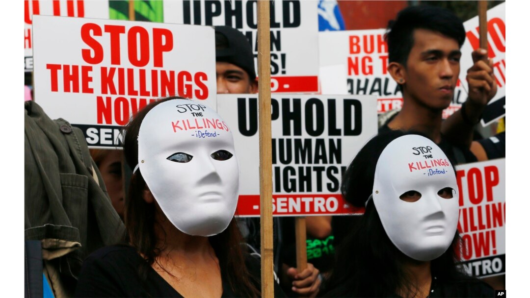 Masked protesters gather for a rally near the Presidential Palace to mark International Human Rights Day, Dec. 10, 2016, in Manila, Philippines. The protesters are calling on the government for an end to extrajudicial killings in the country, which have claimed more than 4,000 lives.