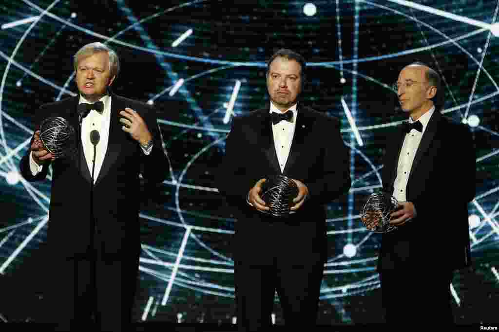 From left, Fundamental Physics co-laureates Brian P. Schmidt, Adam G. Riess, and Saul Perlmutter speak on stage during the second annual Breakthrough Prize Award in Mountain View, California, Nov. 9, 2014.