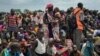 FILE - Men, women and children line up to be registered with the World Food Program for food distribution in Old Fangak, in Jonglei state, one of the worst affected areas for food insecurity in South Sudan, June 17, 2017. 