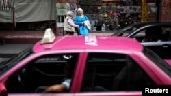 Women wait for public transport in Mexico City, Mexico, Oct. 10, 2018.