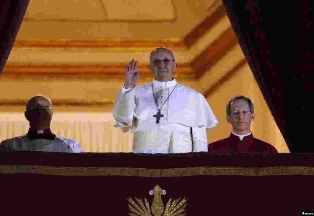 Newly elected Pope Francis, Cardinal Jorge Mario Bergoglio of Argentina appears on the balcony of St. Peter's Basilica after being elected by the conclave of cardinals, at the Vatican, March 13, 2013. White smoke rose from the Sistine Chapel chimney and t