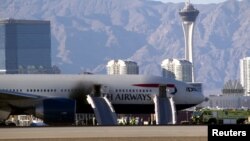 FILE - Soot darkens the door of a British Airways passenger jet after a fire at McCarran International Airport in Las Vegas, Nev., Sept. 8, 2015. 