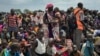 FILE - Men, women and children line up to be registered with the World Food Program for food distribution in Old Fangak, in Jonglei state, one of the worst affected areas for food insecurity in South Sudan, June 17, 2017. 
