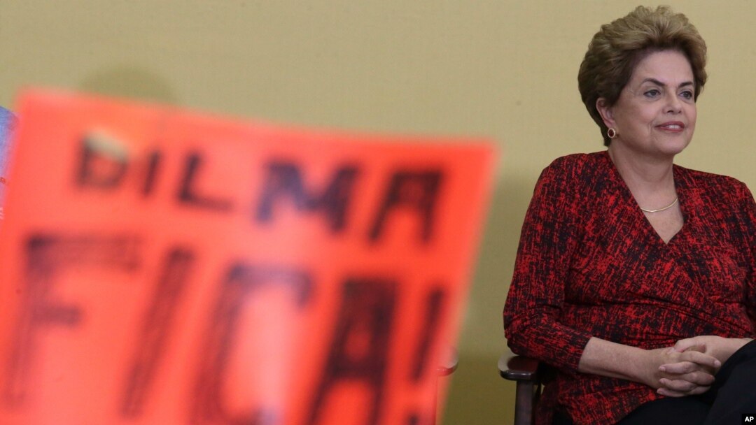 Brazil’s President Dilma Rousseff attends having in front a poster written in Portuguese "Dilma Stay, during ceremony of the Launch Program New Federal Universities, at the Planalto Presidential Palace, in Brasilia, May 9, 2016.