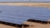 Indian laborers work near solar panels at the Gujarat Solar Park at Charanka in Patan district, about 250 kilometers (155 miles) from Ahmadabad, India, Apri. 14, 2012. 