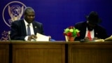 President of South Sudan, Salva Kiir (R) and South Sudan rebel leader Riek Machar sign a final power-sharing deal between arch-foes, Aug. 5, 2018, in Khartoum. 