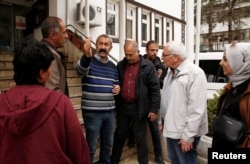 Tunceli Mayor Mehmet Macoglu from the Communist Party of Turkey (TKP) chats with people outside the municipality building in Tunceli, Turkey, April 15, 2019.