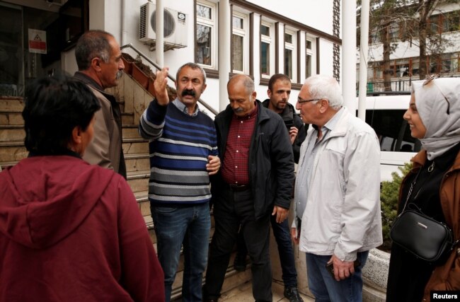 Tunceli Mayor Mehmet Macoglu from the Communist Party of Turkey (TKP) chats with people outside the municipality building in Tunceli, Turkey, April 15, 2019.