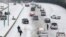 Charlotte Mecklenburg Police Officers work to assist motorists as they attempt to drive up a hill that is covered in snow in Charlotte, North Carolina, Feb. 12, 2014. 