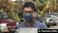 Amit Khanna, a resident of Gurgaon on the outskirts of the Indian capital, uses a face mask to protect himself from air pollution when he is outside.
