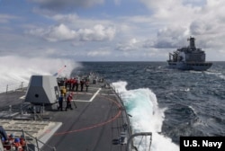 A wave breaks on the forecastle of the Arleigh Burke-class guided-missile destroyer USS Wayne E. Meyer as the ship begins its approach to the fleet replenishment oiler USNS Rappahannock for a replenishment-at-sea in the western Pacific region, May 26, 2017.