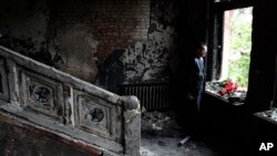 A man lays flowers inside the burnt-out Trade Unions Building in Odessa, Ukraine, May 4, 2014.