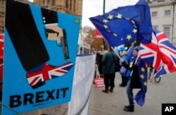 Protestors demonstrate opposite Parliament against Britain's Brexit split from Europe, in London, Thursday, Dec. 6, 2018.