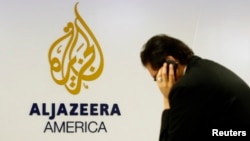 A man works at a desk in the Al Jazeera America broadcast center in New York, Aug. 20, 2013. 