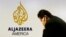 A man works at a desk in the Al Jazeera America broadcast center in New York, August 20, 2013. 