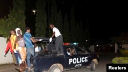 Volunteer rescue workers travel on a police van used to evacuate victims after a bombing to Asokoro General Hospital in Abuja May 1, 2014.