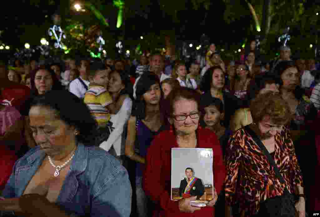 Supporters of Venezuelan President Hugo Chavez pray during a mass in Caracas, December 31, 2012.