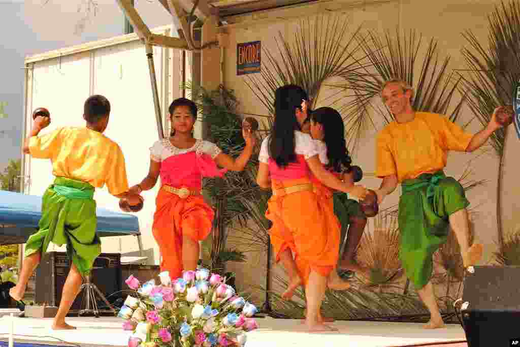 Geoffrey Nelson and his Cambodian colleagues dance Robaim Kuos Tralauk, a popular traditional Khmer dance, which is often translated as 'Coconut Dance.'