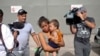 File- Adalicia Montecino and her husband Rolando Bueso Castillo walk with their year-old son Johan Bueso Montecinos, who became a poster child for the U.S. policy of separating immigrants and their children, in San Pedro, Feb. 4, 2017.