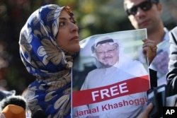 Tawakkol Karman, the Nobel Peace Prize laureate for 2011 holds a picture of missing Saudi writer Jamal Khashoggi as she speaks to journalists near the Saudi Arabia consulate, in Istanbul, Turkey.