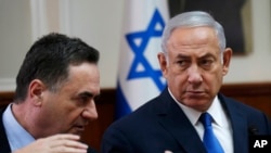 FILE - Israeli Prime Minister Benjamin Netanyahu listens to then-Transportation and Intelligence Minister Yisrael Katz during the weekly Cabinet meeting at the Prime Minister's office in Jerusalem, Sept. 5, 2018.