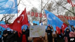 FILE - Several hundred Uighurs living in Turkey, carrying Turkish flags and flags of what ethnic Uighurs call East Turkestan, protest alleged oppression by the Chinese government to Muslim Uighurs in far-western Xinjiang province, in Ankara, Turkey, Feb. 5, 2018. 