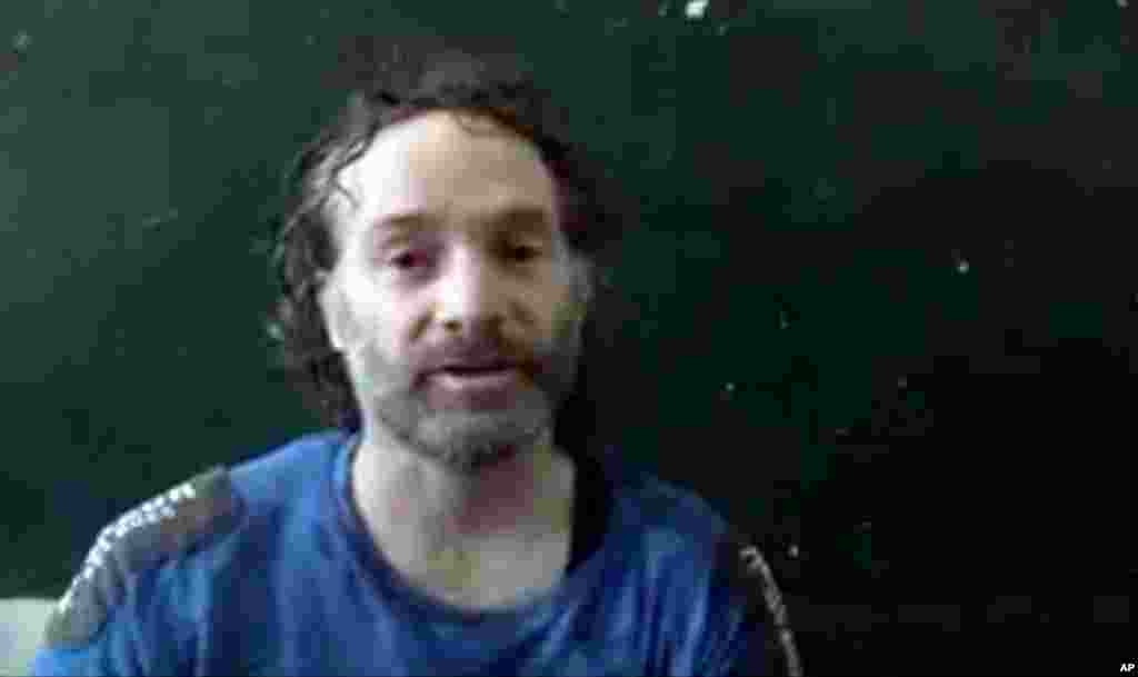 This image, taken from undated video obtained by The Associated Press, is believed to be Peter Theo Curtis, a U.S. citizen held hostage by an al-Qaida-linked group in Syria, as he delivers a statement.